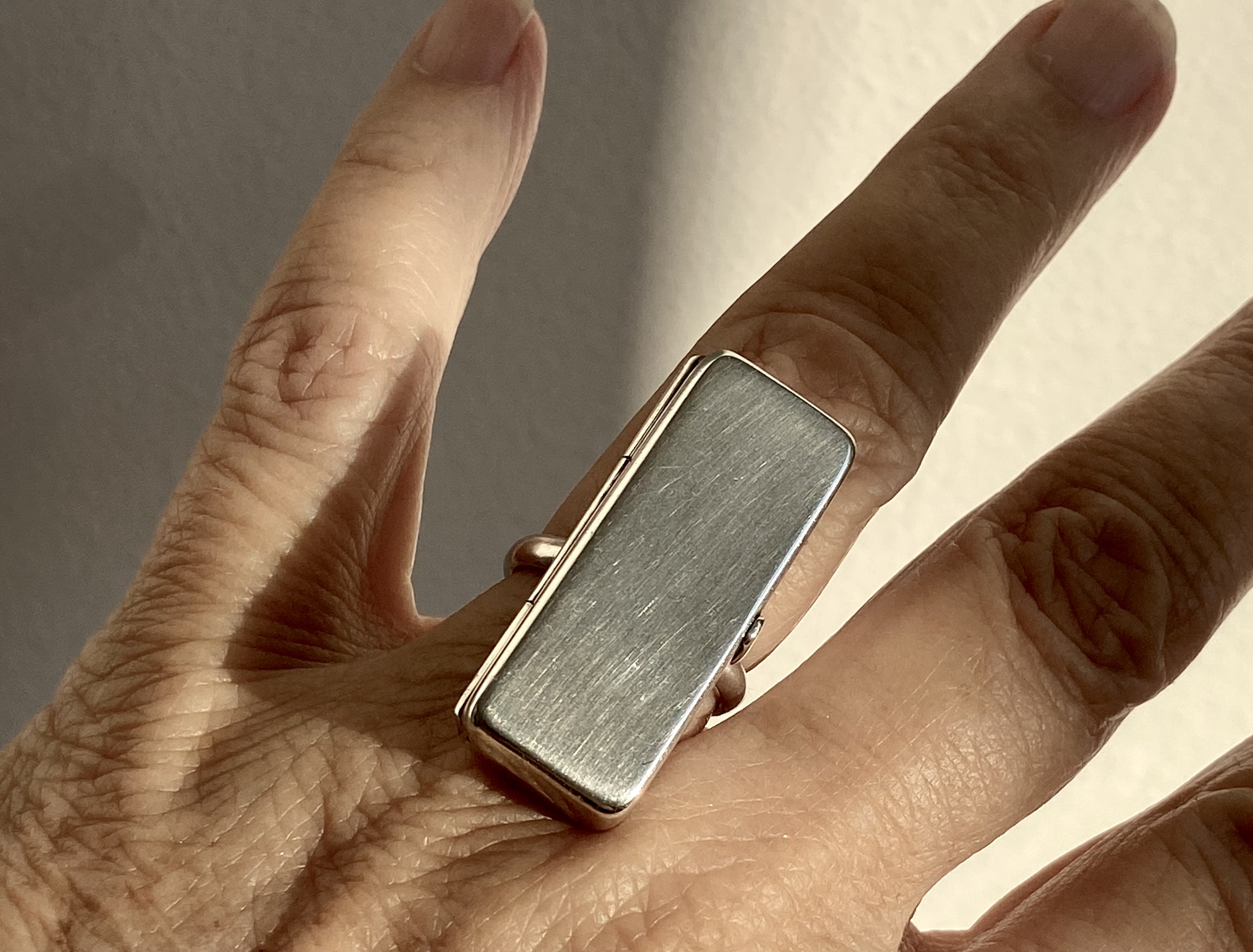 Discover the exquisite Astrid Fog Georg Jensen Pill Box Ring, a unique blend of functionality and elegance. Perfect for storing small treasures or medication, this stunning ring adds a touch of sophistication to any outfit. Shop now and elevate your jewelry collection!